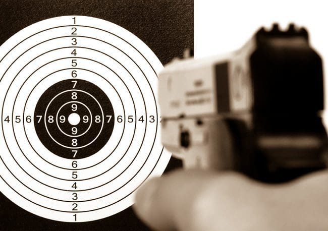 A gun is being fired at the target.