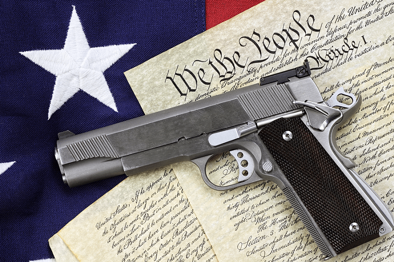 A gun sitting on top of an american flag.