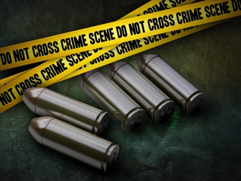 A group of bullets and yellow tape with crime scene tape.