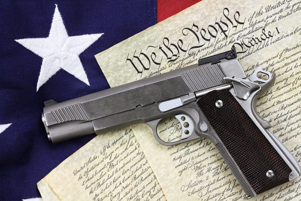 A gun sitting on top of an american flag.